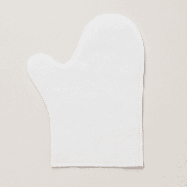 Manopla desechable blanca sin dedos, fabricada en material fino y flexible, ideal para estética o higiene, sobre fondo gris claro. Manopla desechable transparente, sin dedos. Paquete de 50 unidades. Perfecta para tratamientos corporales, higiene o spa.