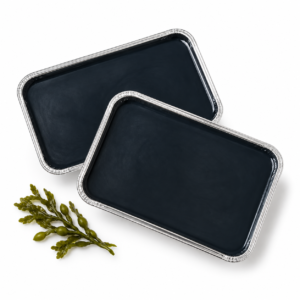 Dos bandejas de cera de algas con un detalle decorativo de alga marina sobre fondo blanco